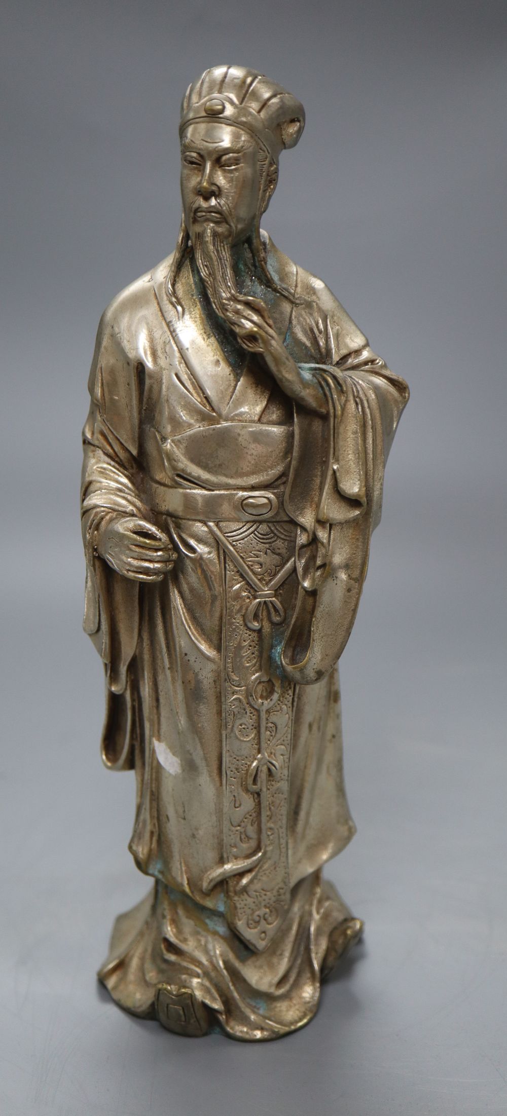 A Chinese silvered metal figure of an elder, height 24cm